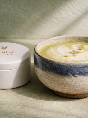 Matcha latte and tea canister still life